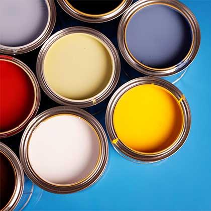 Buckets of paint on a blue surface