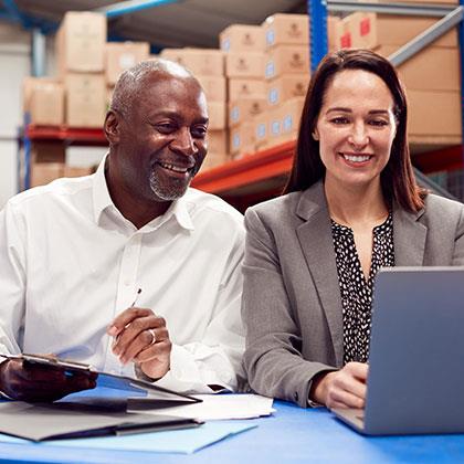 Two people looking at a laptop