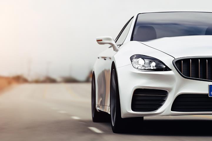 front view of white car driving on the road