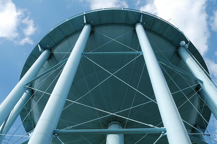 looking up at the bottom of a white water tower