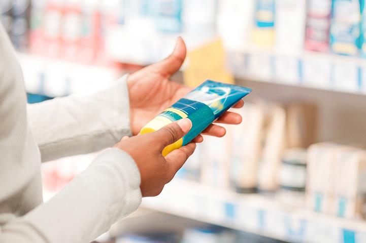 person looking at different products in a store aisle