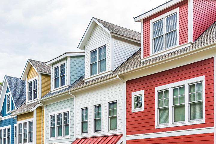 row of colorful red yellow blue white green painted townhouses