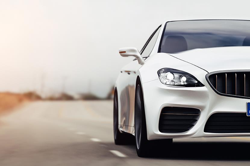 front view of white car driving on the road