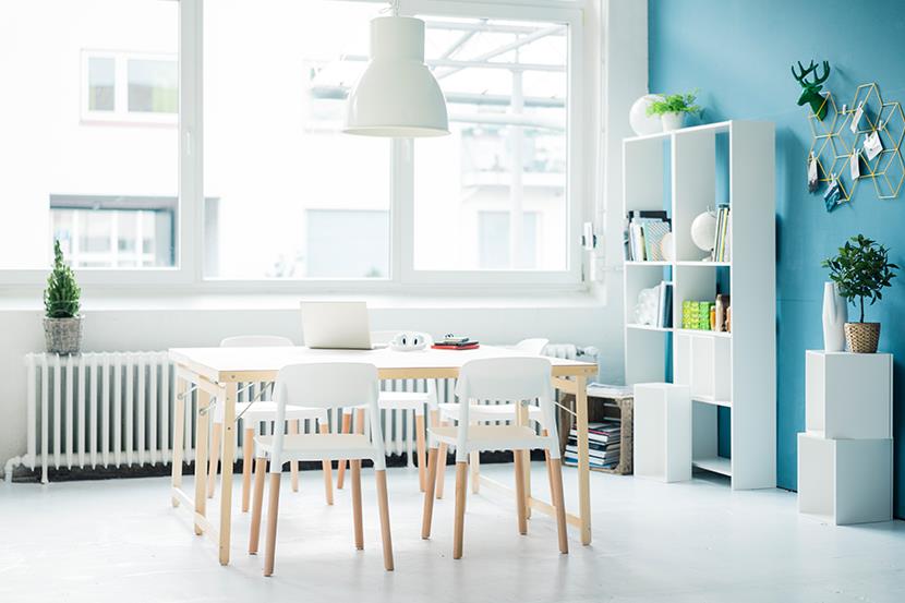 open room with table and chairs blue wall detail