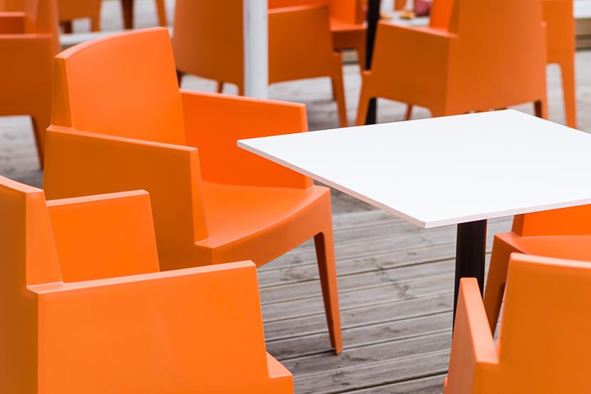 bright orange chairs white table sitting outside on a deck