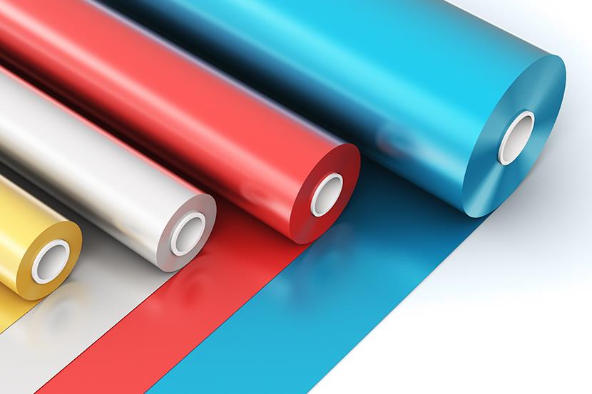 four rolls of yellow white red blue pvc polythene plastic on white