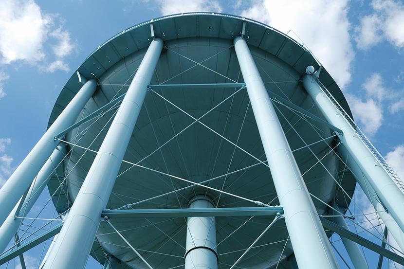 looking up at the bottom of a white water tower