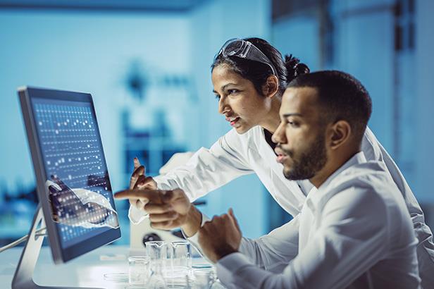 two people working at a computer