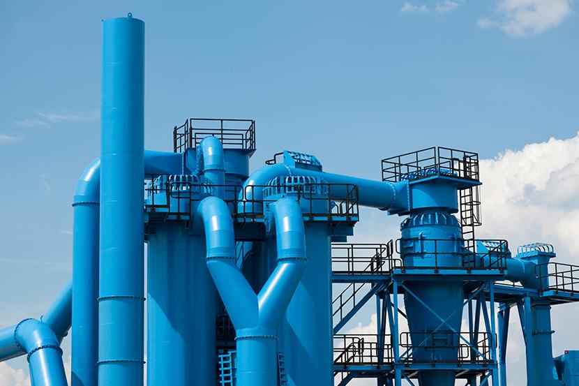 exterior shot of industrial facility's blue pipes